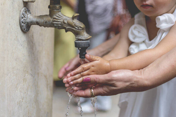 Little girl washing her hands