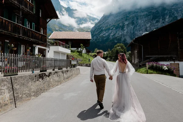 Back View Couple Holding Hands Walking Road Town Alps — Stock Photo, Image