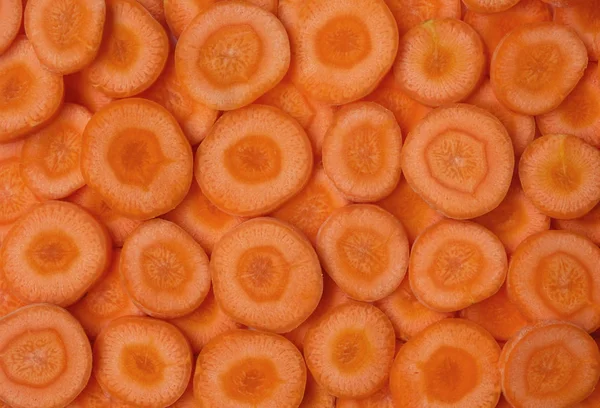 Orange round frash cut carrot peels background