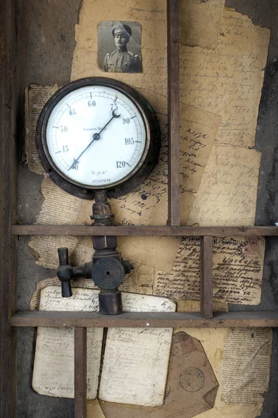 Old vintage water pressure meter on a old letters background