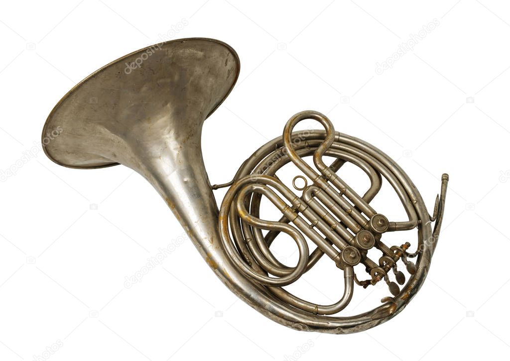 Old vintage rusty French horn on a withe background, isolated