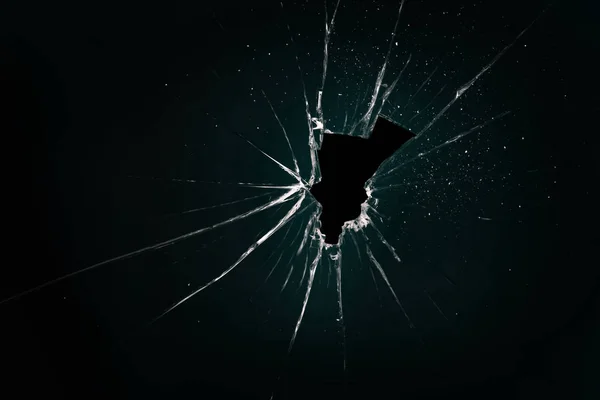 Broken and cracked glass with hole — Stock Photo, Image