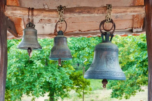 Old bells hanged on the wooden log