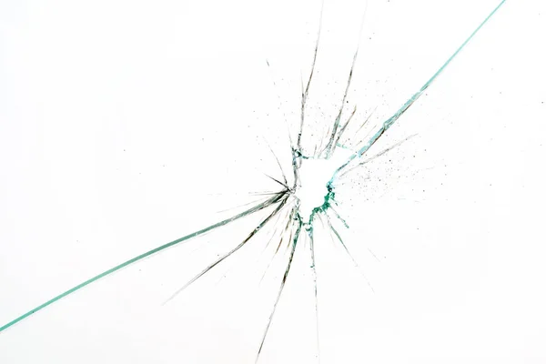 Разбитое и разбитое стекло с отверстием — стоковое фото
