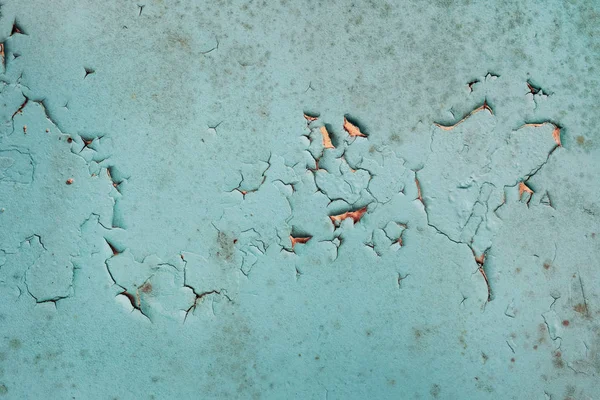 Old cracked wall with moldy peeling blue painting