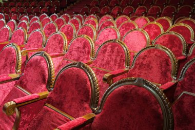 Boş kırmızı ahşap ve kadife sandalyeler.