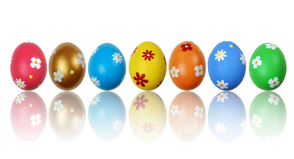 Set of colorful painted Easter eggs reflecting on the white background