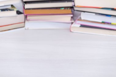 Many books on a wooden table. Copy space. Education, go back to school.