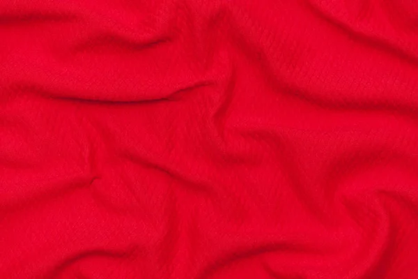 Abstract red fabric texture background. Cloth soft wave. Close up, draped.