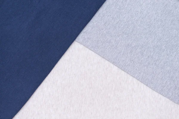 Grey, blue, beige cotton textile, fabric background.