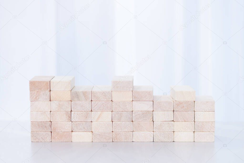 Close-up of wooden blocks on white sunlight background. Stability concept.