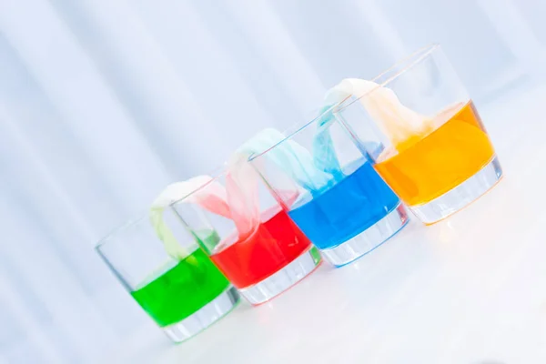 Glasses with colored liquid. Chemical experiments for children.