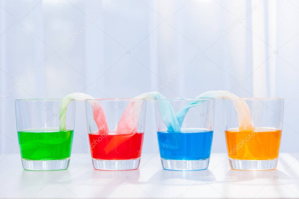 Glasses with colored liquid. Chemical experiments for children.