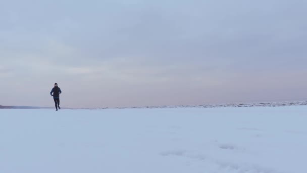 Ένας Άνθρωπος Που Τρέχει Χειμώνα Μια Όμορφη Παραλία Χιονισμένο — Αρχείο Βίντεο