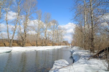 nehir baharda uyanır. Buz erimiş, ama büyük kar bloklarını hala bankaların defalarca su asmak