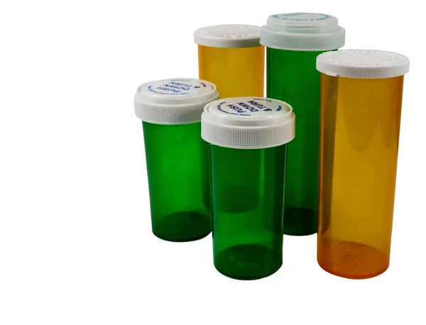 Green and yellow pharmaceutical medicine bottles — Stock Photo, Image