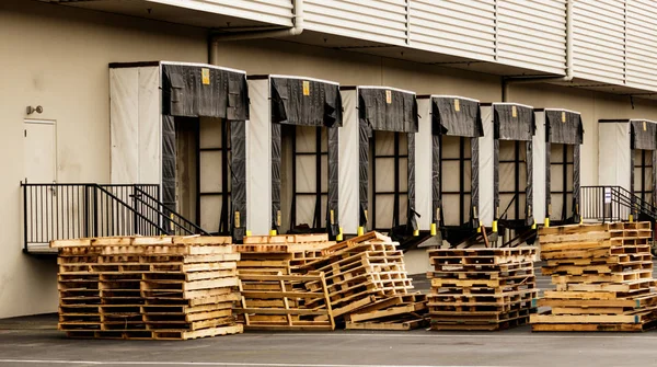 Warehouse truck bays with stacked wooden pallets