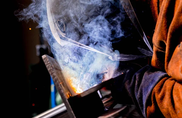 Man tig welding steel iron plates with brilliant bright white star burst bloom — Stock Photo, Image