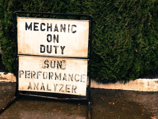 Small town mechanic on duty sign on a sidewalk — Stock Photo, Image