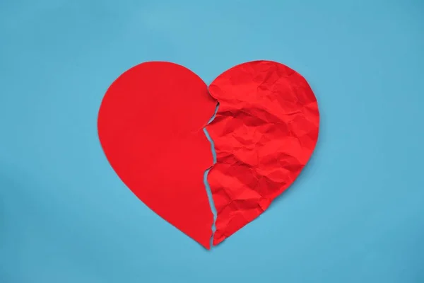 Red crumpled paper shaped as a torn love. Infarction and divorce icon