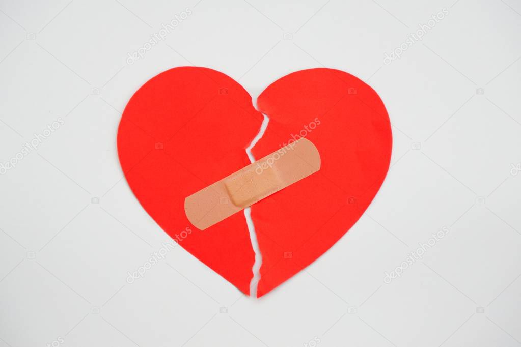 Paper broken heart on white background with clipping paths. lose up.