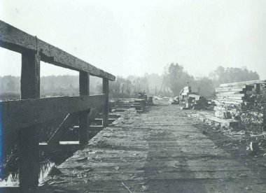 View of rebuilding wooden bridge along lake  clipart