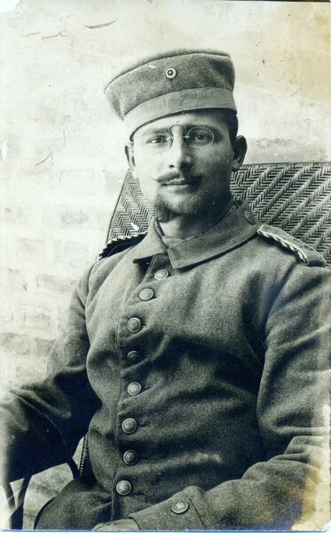 german soldier with glasses posing at camera in studio