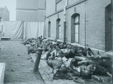Dead civilian victims laying on sidewalk with german guard clipart