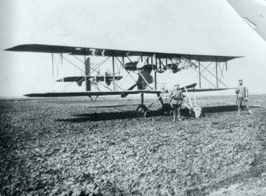 Two german soldiers on guards duty at captured two-engine plane clipart