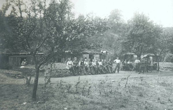 german soldiers posing in front of shelters at camera