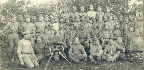 platoon russian soldiers with Maxim machine guns posing at camera