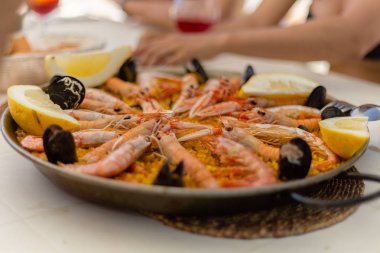 Paella: geleneksel tavada bir geleneksel İspanyolca/Akdeniz deniz ürünleri çanak. Arkadaşlarınızla ve ailenizle denizin kenarında paylaşmak için mükemmel bir yemek.