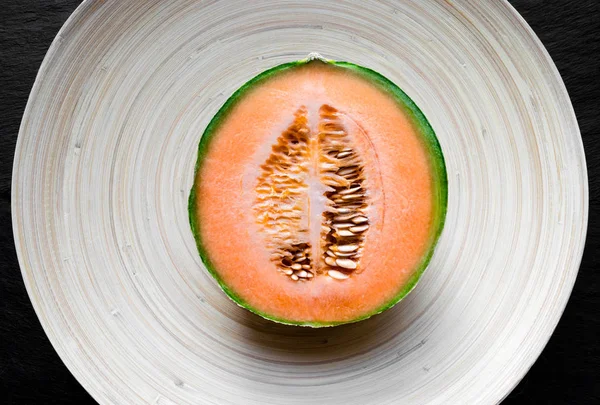 Half of Hami Melon Fruit on Bamboo Plate — Stock Photo, Image