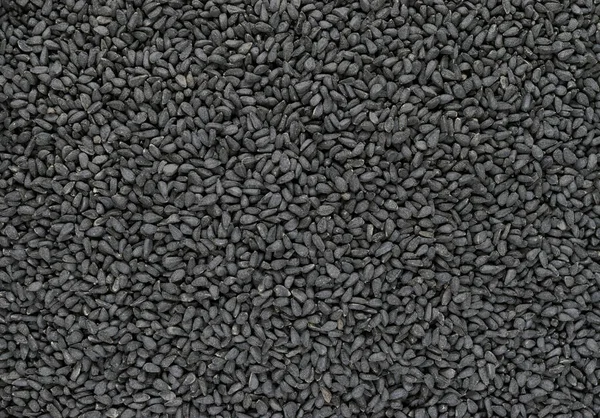 Schwarzkümmel (Nigella sativa oder Kalonji) Samen Hintergrundoberfläche — Stockfoto
