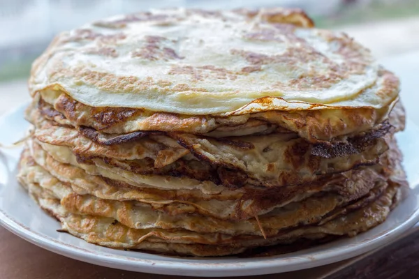 Pile of tasty pancakes. Traditional russian pancakes. Sweet breakfast concept. Dessert concept. Food background. High-calorie food.