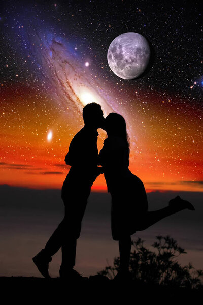 Silhouette of a loving couple against space fantastic landscape