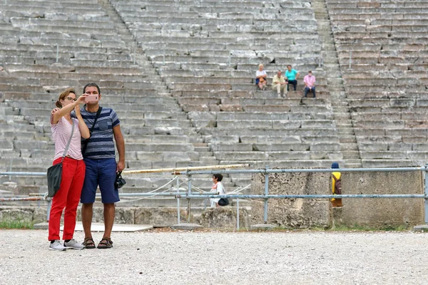 I turisti visitano il Teatro Epidauro (Peloponneso, Grecia) che è uno dei più grandi esempi di architettura greca — Foto Stock