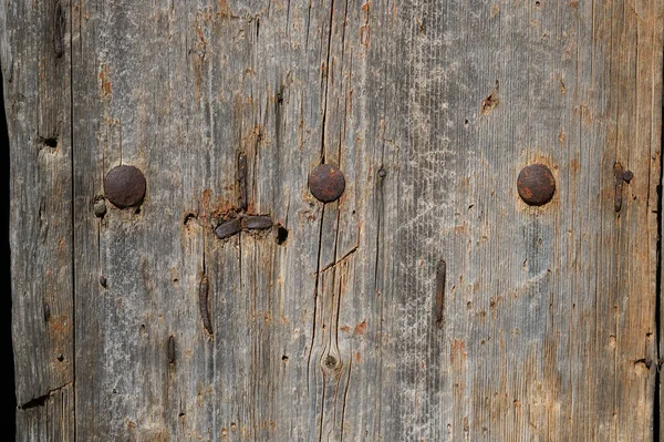Detail of an old wooden door with nails — Stock Photo, Image