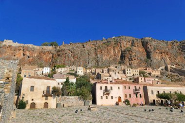 Turistler, Monemvasia 'nın efsanevi şatosunun içindeki kenti ziyaret ediyorlar.