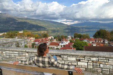 Ioannina, 01 Kasım 2019 Bir turist kentin ve Ioannina Gölü, Epirus, Yunanistan 'ın manzarasının keyfini çıkarıyor