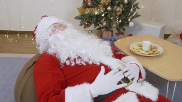 Père Noël se détend après avoir trop mangé 