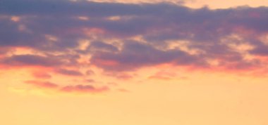 Akşam gökyüzünde muhteşem renkli bulutlar. Gün batımında gökyüzünde parlak, pembe bulutlar. Güzel bir akşam manzarası. Soyut, mor pembe arka plan. Canlı renkli fotoğraf..