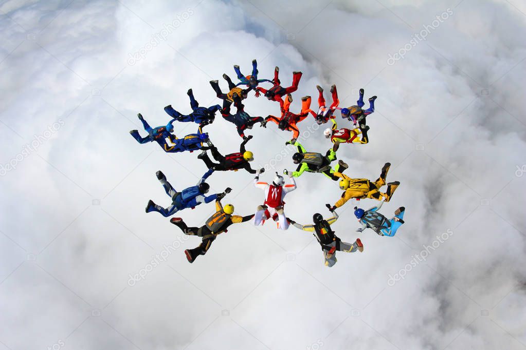 A big group of skydivers is in the sky.