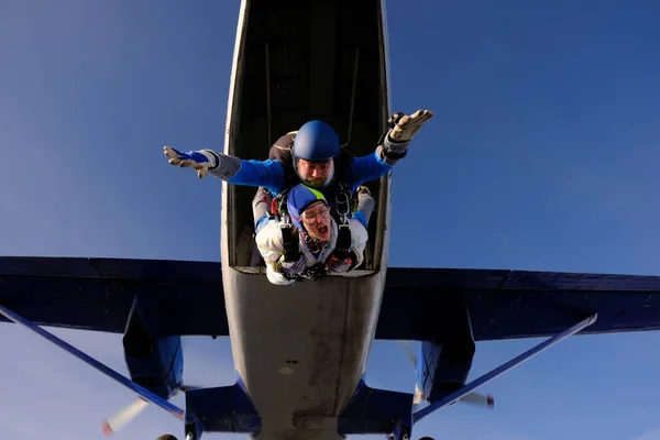 Skydiving. Tandem jump. People in the sky. A man and a woman are flying together.