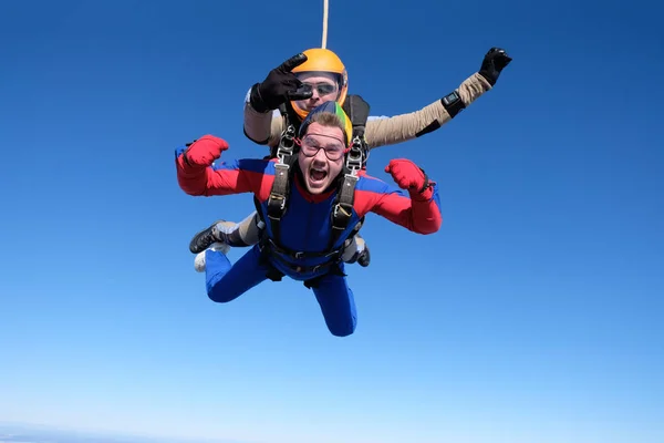 Skydiving. Tandem jump. Two guys are in the sky.