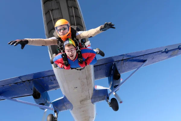 Skydiving. Tandem jump. Two guys are in the sky.