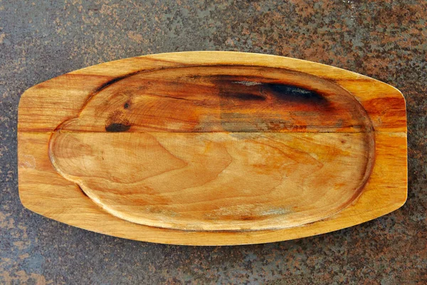 a cutting board made of wood lies on a table top view