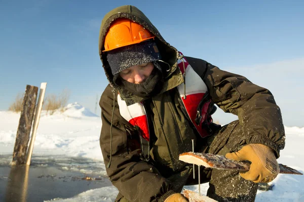 Worker collects formwork for the ice hole — Stock Image Worker collects formwork for the ice hole Royalty Free Stock Photos