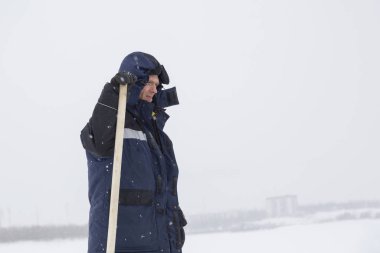 Elinde kürekle bir işçinin portresi.