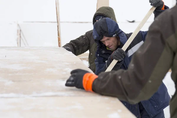 Two workers in overalls at a construction site — Stock Image Two workers in overalls at a construction site Stock Picture
